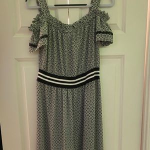 Long black and white flowy dress with flowers on the bottom.